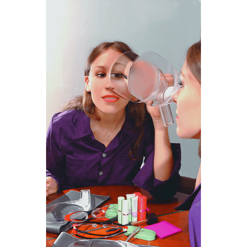 Woman using BeautyLook magnifier to apply makeup at a beauty salon magnifying mirror.